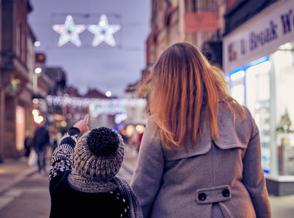 mother and son walking through hereford looking at Christmas lights